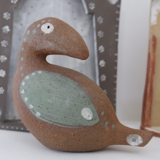  bird sculpture green on red clay 